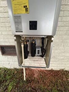 Rinnai RXP installed, exterior with cover off to see insulated lines