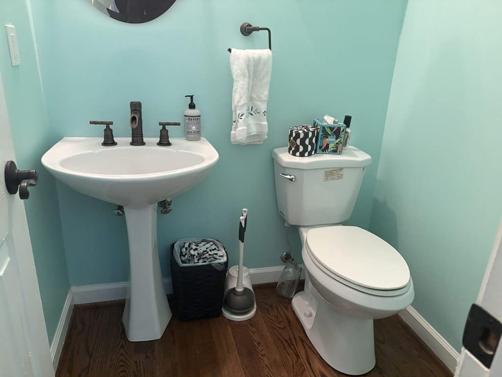 BEFORE — the guest bath with the old pedestal sink | Guest bathroom with a pedestal sink before ARC Plumbing installed a vanity in Haddon Hall, Apex, NC