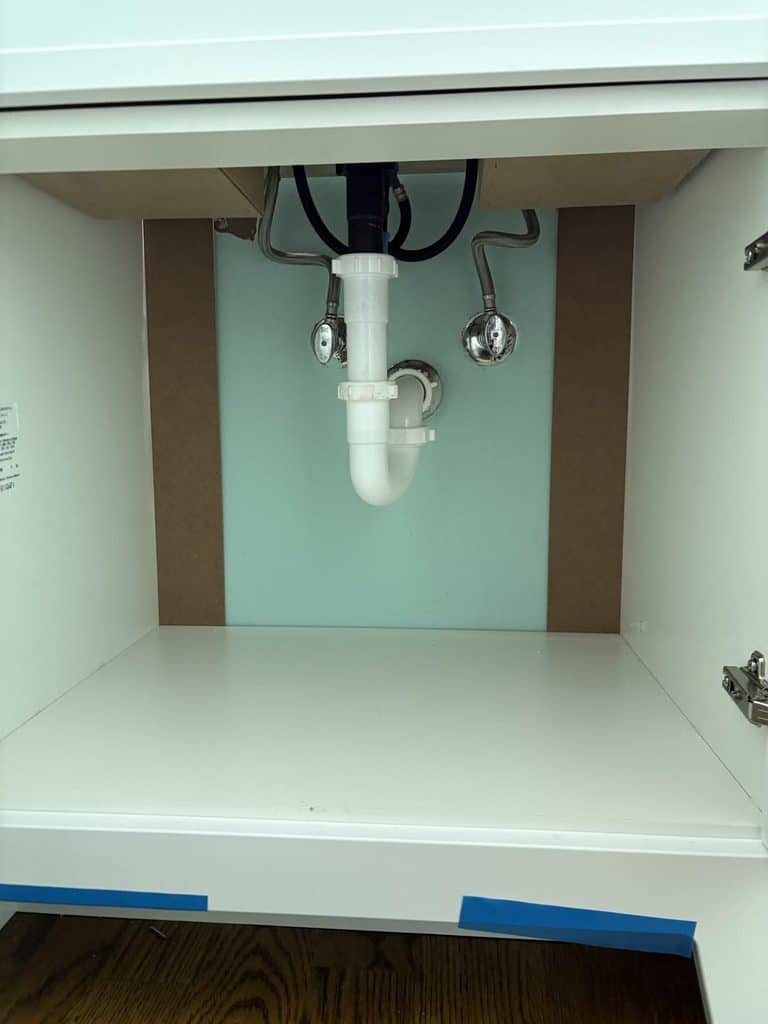 AFTER — new shutoffs and reconfigured trap inside the vanity | New shutoff valves and drain trap inside a new vanity installed by ARC Plumbing in Apex, NC
