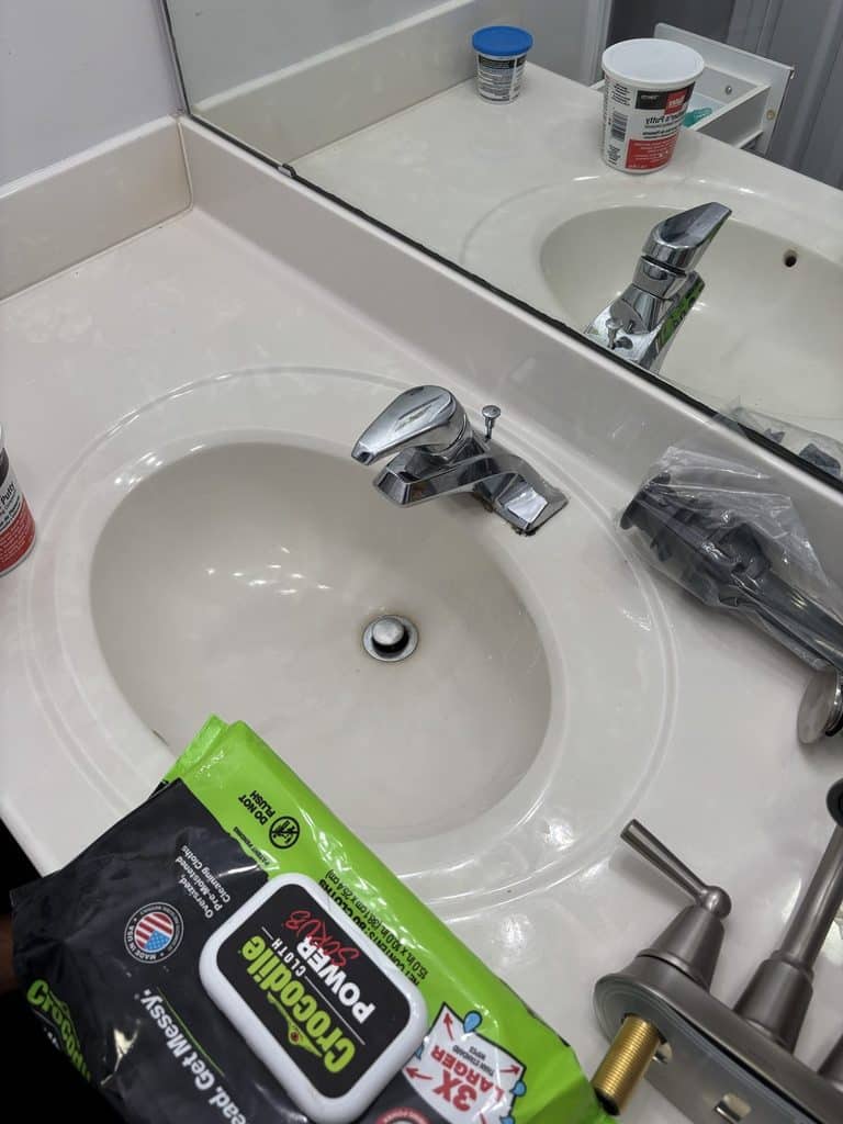 BEFORE — the old chrome faucet | Old chrome bathroom faucet before replacement in a Raleigh, NC home |
