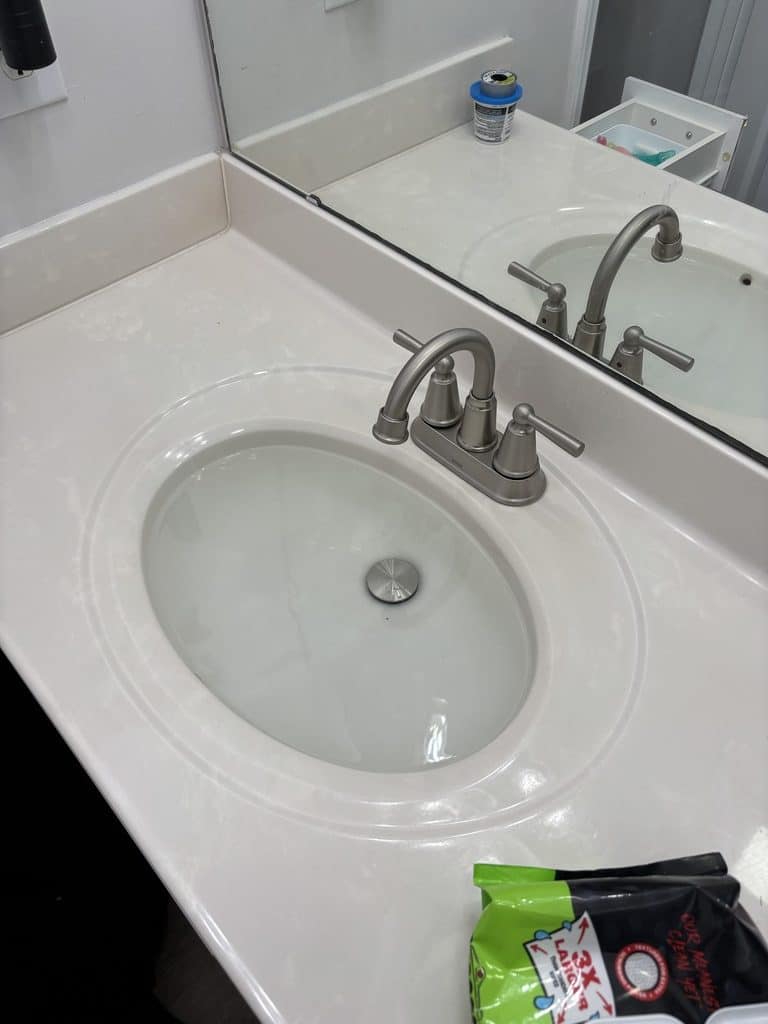 AFTER — the homeowner's new brushed-nickel faucet, installed and leak-checked | New brushed nickel bathroom faucet installed by ARC Plumbing in Woodlawn, Raleigh, NC |