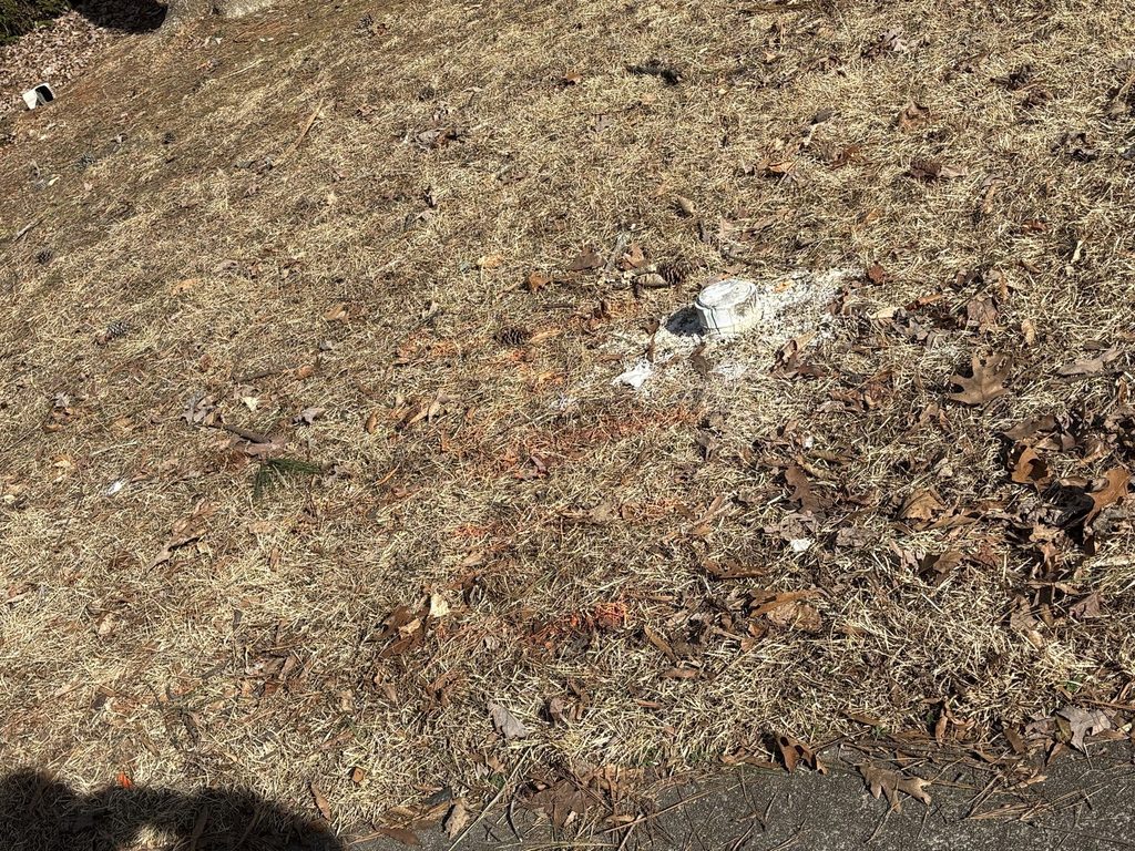 | BEFORE — the cleanout at the street overflowing, cap blown off | Sewer cleanout overflowing at the street with its cap blown off in Wake Forest, NC |