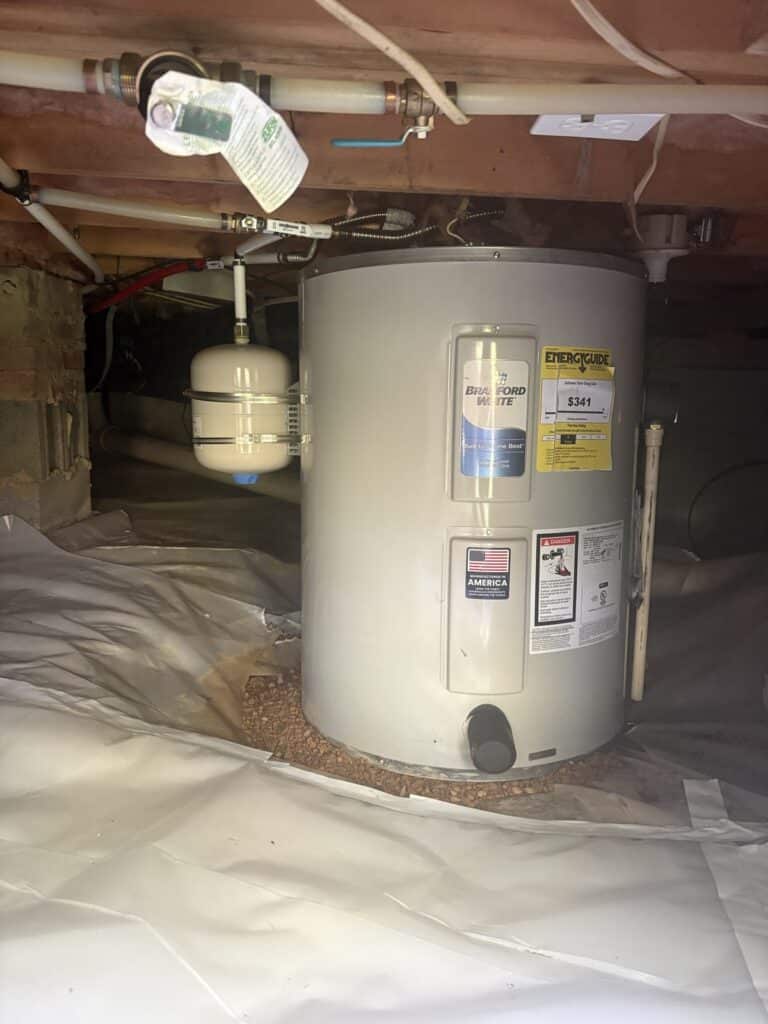 AFTER — new Bradford White tank and expansion tank, set level on gravel | New Bradford White water heater with expansion tank on a level gravel pad in an Angier, NC crawlspace |