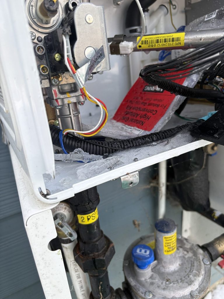 Inside of a frozen Navien tankless water heater opened by an ARC plumber in Angier, NC |