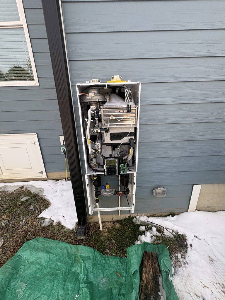 DURING — troubleshooting the old unit before calling it | ARC plumber troubleshooting a freeze-damaged Navien tankless water heater in Angier, NC |
